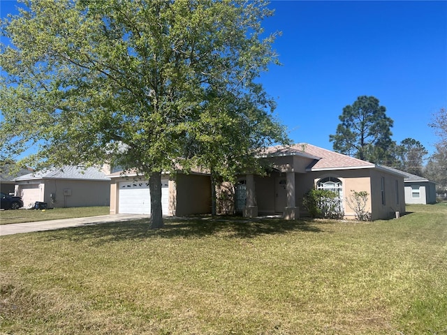 view of front of house with stucco siding, driveway, a garage, and a front yard