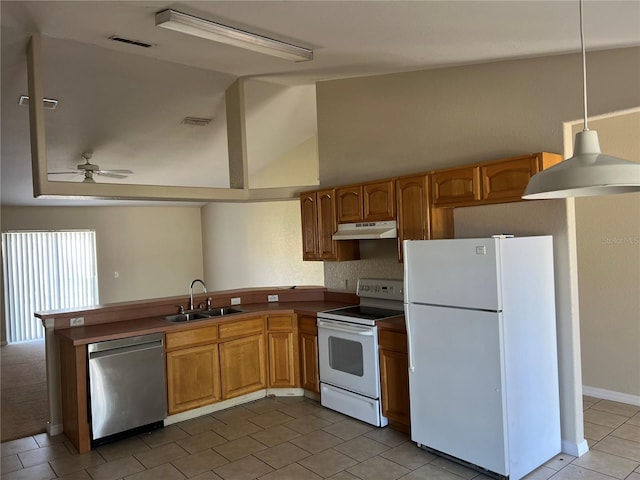 kitchen featuring white appliances, visible vents, under cabinet range hood, and a sink