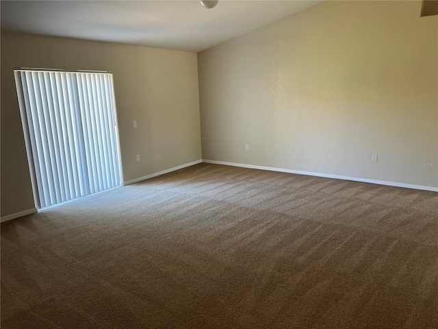 unfurnished room with baseboards and carpet floors