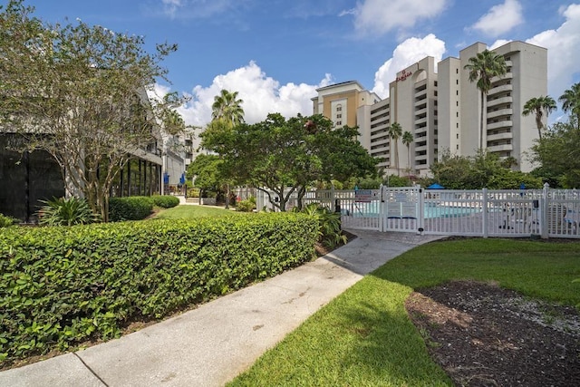 view of property's community featuring a swimming pool and fence