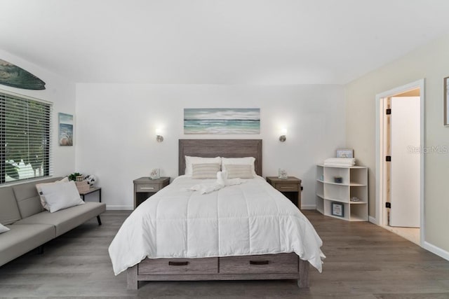 bedroom with wood finished floors and baseboards