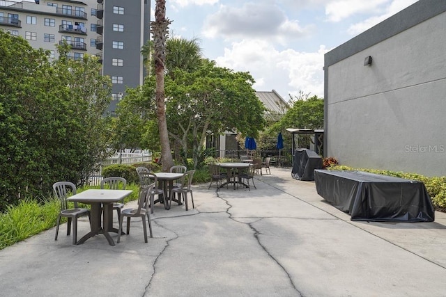 view of patio with a grill and outdoor dining area