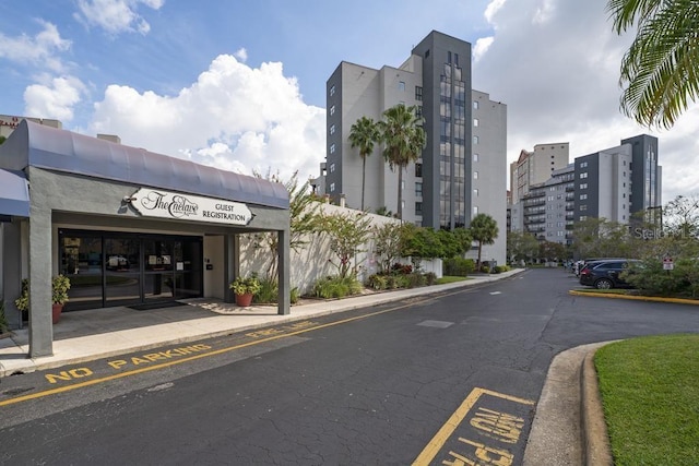 view of property featuring uncovered parking and a city view