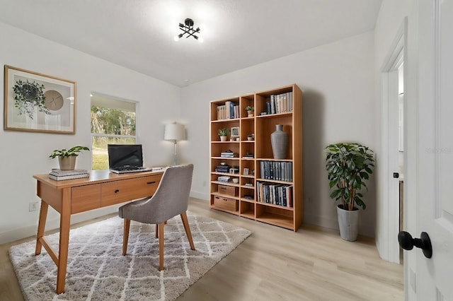 home office featuring wood finished floors and baseboards