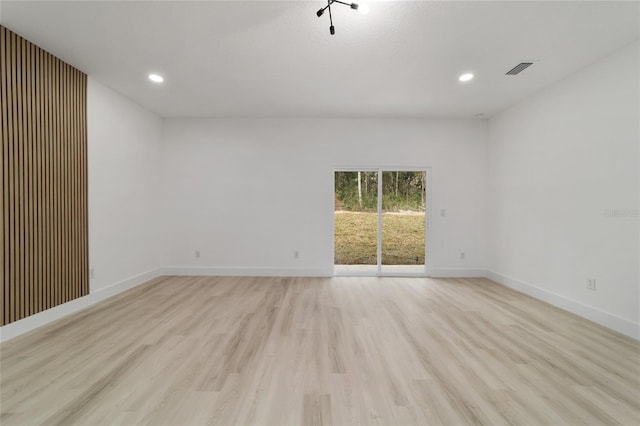 unfurnished room with visible vents, recessed lighting, baseboards, and light wood-type flooring