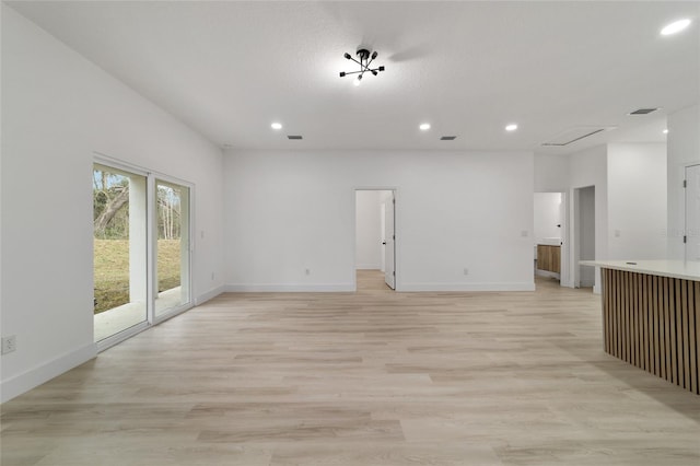 unfurnished living room featuring recessed lighting, visible vents, baseboards, and light wood finished floors