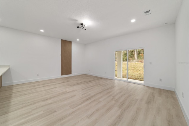 unfurnished room with visible vents, recessed lighting, baseboards, and light wood-style floors