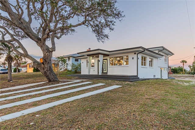 view of front of house featuring a front yard and stucco siding