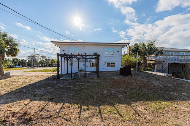 back of property featuring a pergola