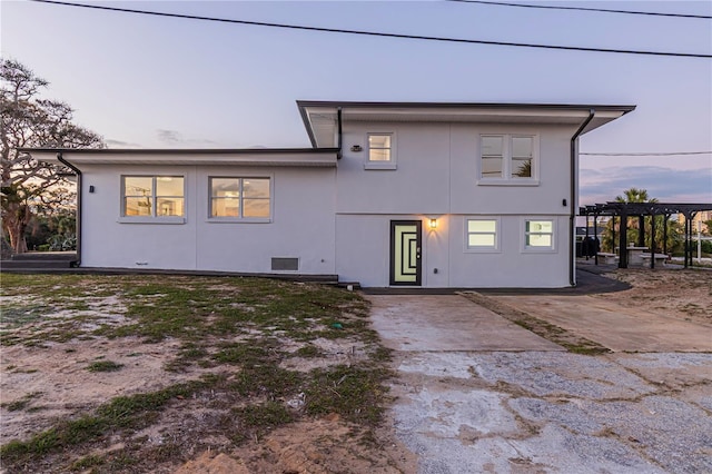 back of house with a pergola, a patio, and stucco siding