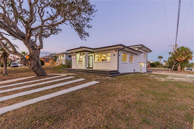 view of front of house featuring a yard and stucco siding