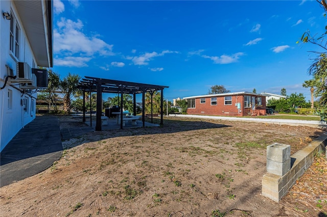 view of yard with a pergola and a patio