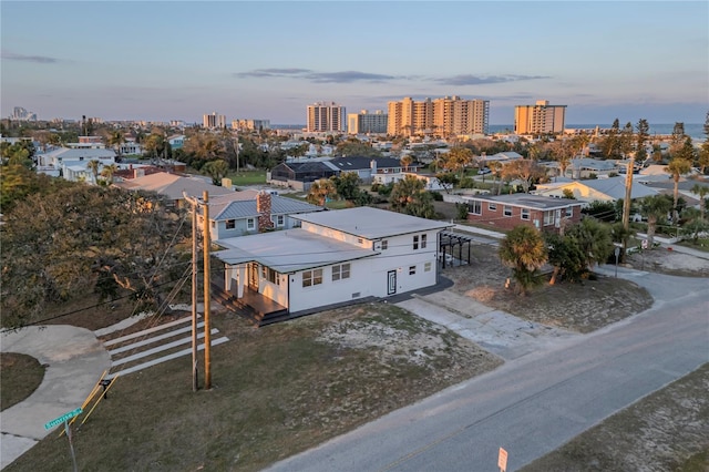 aerial view at dusk featuring a city view