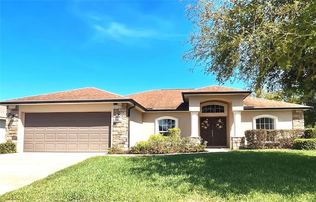 view of front facade featuring a front lawn, an attached garage, stone siding, and stucco siding