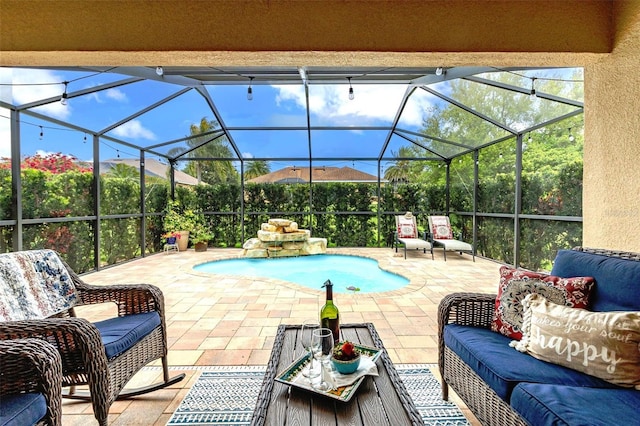 view of pool featuring glass enclosure, an outdoor hangout area, and a patio area