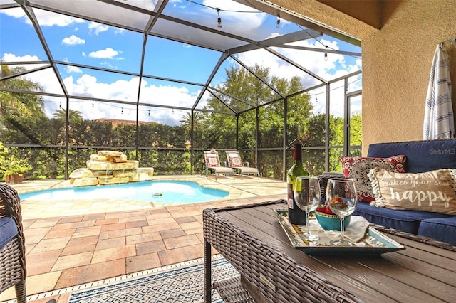 outdoor pool with an outdoor living space, glass enclosure, and a patio area