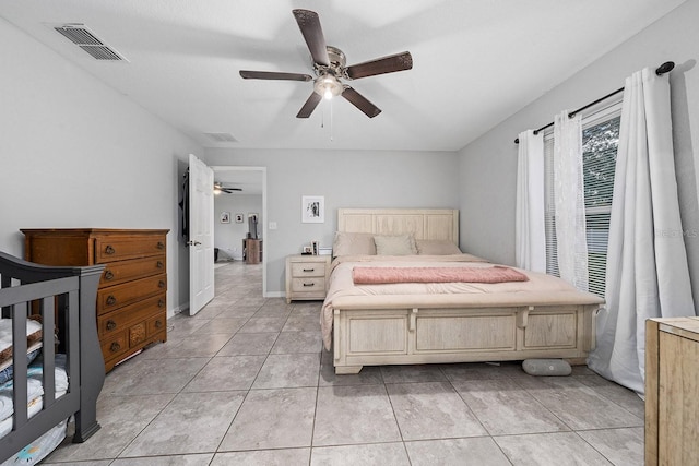 bedroom with visible vents, ceiling fan, baseboards, and light tile patterned floors