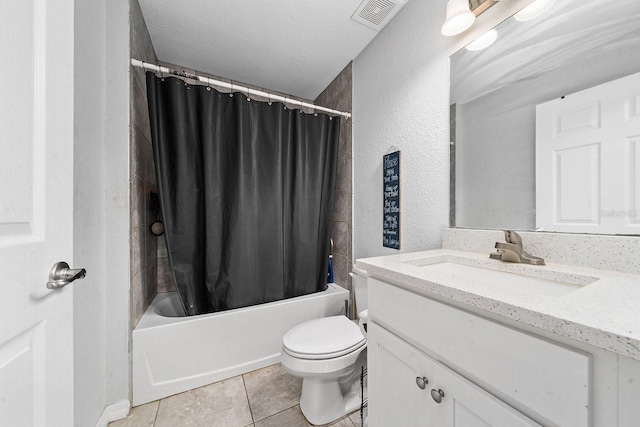 full bathroom featuring a textured wall, toilet, vanity, visible vents, and tile patterned floors