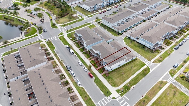 drone / aerial view with a water view and a residential view