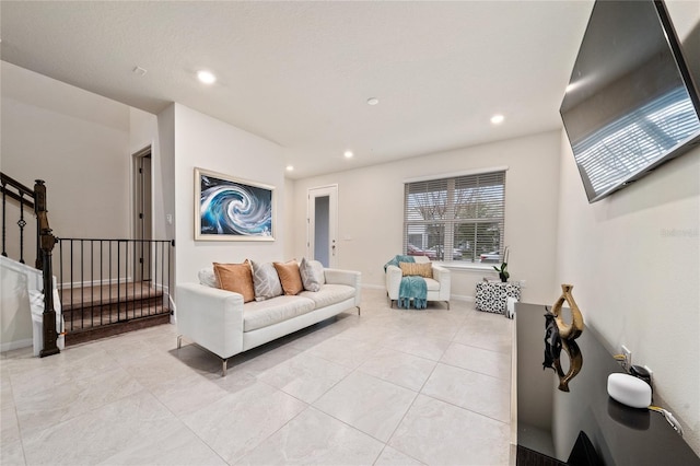 living area featuring light tile patterned floors, baseboards, stairway, and recessed lighting