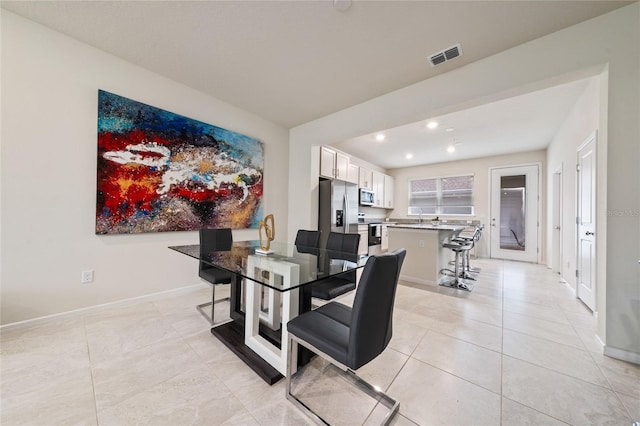 dining space featuring light tile patterned floors, recessed lighting, visible vents, and baseboards