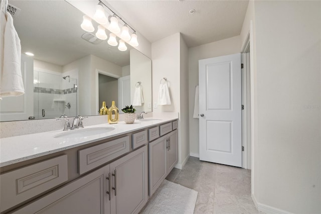 full bathroom featuring double vanity, a shower stall, visible vents, and a sink