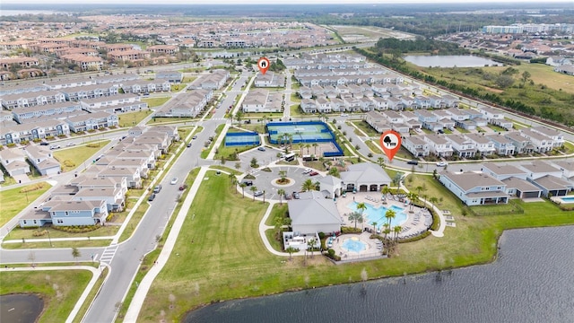 drone / aerial view featuring a water view and a residential view