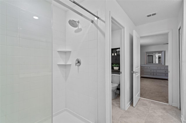 bathroom featuring visible vents, toilet, a shower stall, a textured ceiling, and tile patterned floors