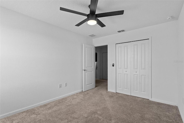 unfurnished bedroom featuring a closet, carpet, visible vents, and baseboards