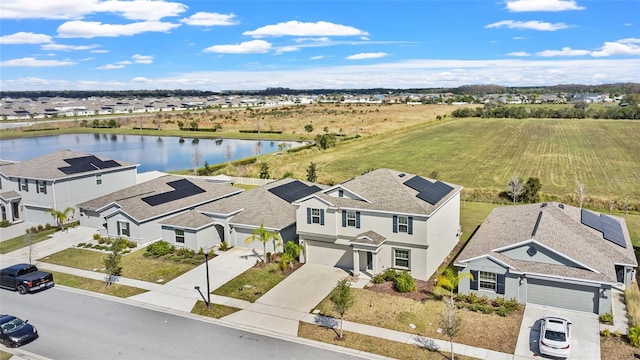 birds eye view of property with a residential view and a water view