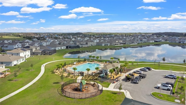 drone / aerial view with a residential view and a water view