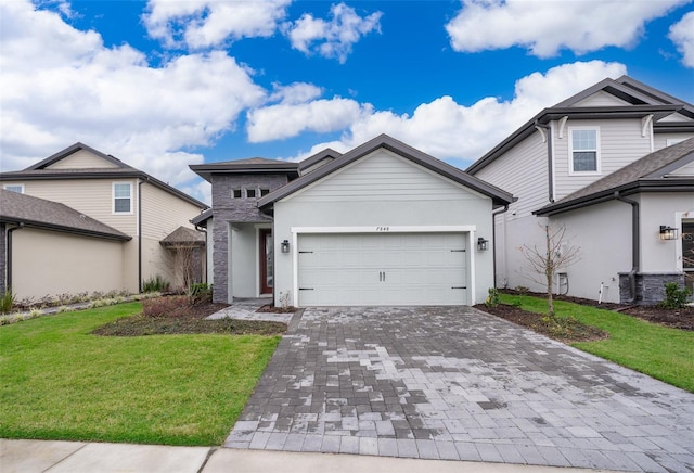 view of front of home with a garage, stone siding, decorative driveway, stucco siding, and a front lawn