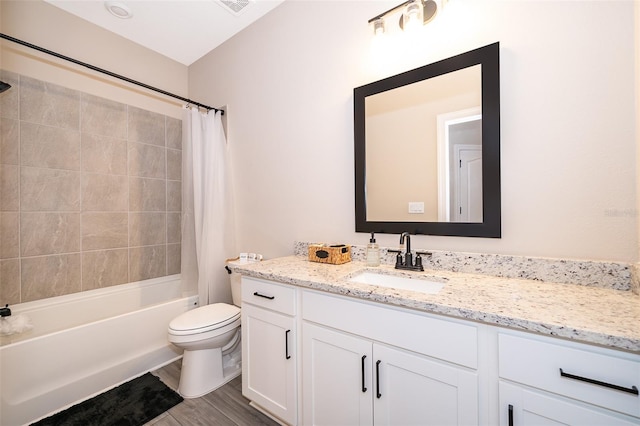 bathroom featuring toilet, shower / bath combo, wood finished floors, and vanity