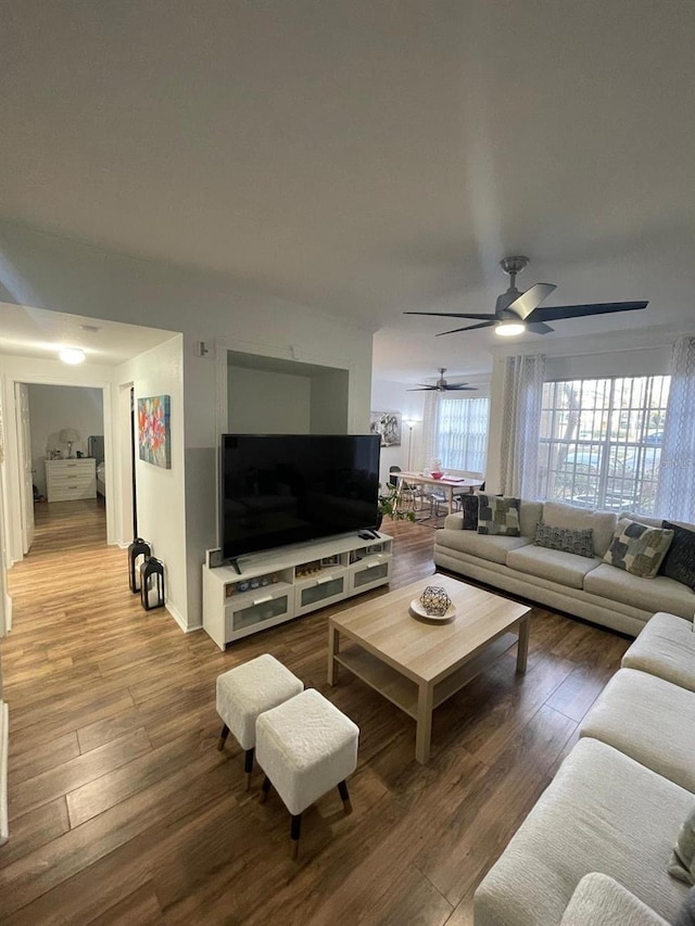 living area featuring ceiling fan and wood finished floors