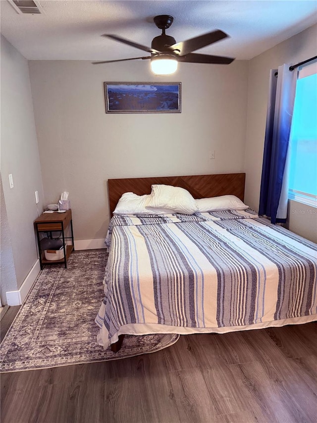 bedroom with ceiling fan and wood finished floors