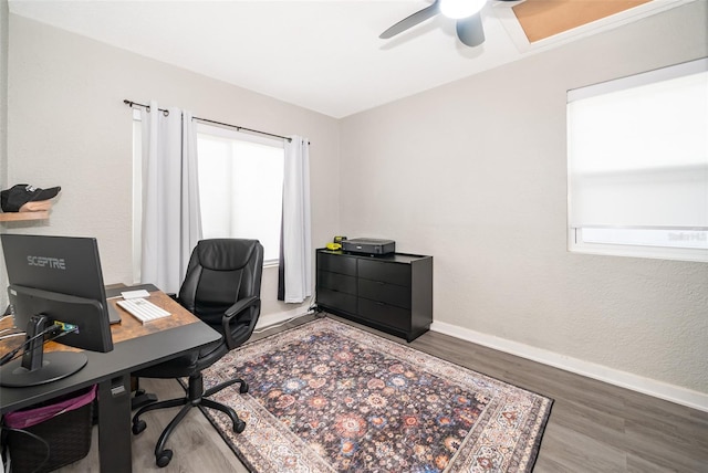 home office featuring ceiling fan, wood finished floors, and baseboards