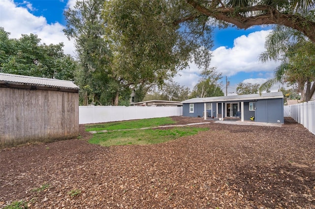 exterior space featuring a fenced backyard and a patio