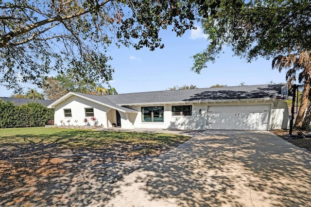 ranch-style house featuring a garage, driveway, and stucco siding