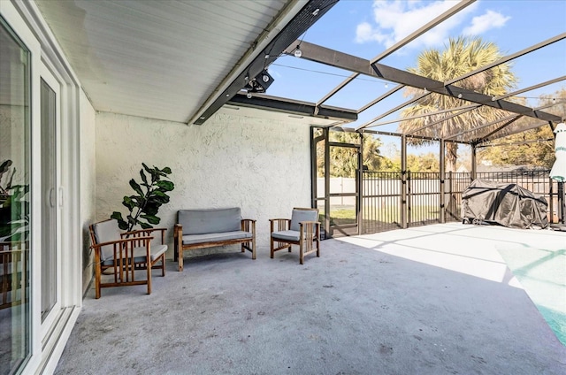 view of patio featuring a lanai