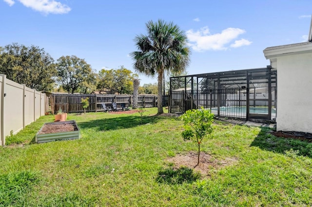 view of yard featuring a lanai, a fenced backyard, a swimming pool, and a vegetable garden