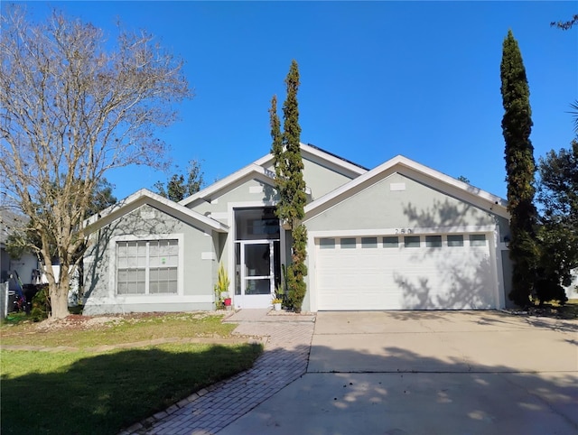 ranch-style house featuring a front lawn, a garage, driveway, and stucco siding