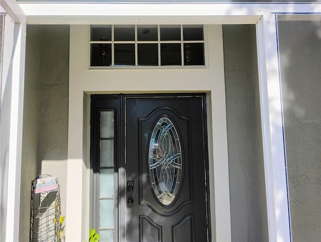 property entrance with stucco siding