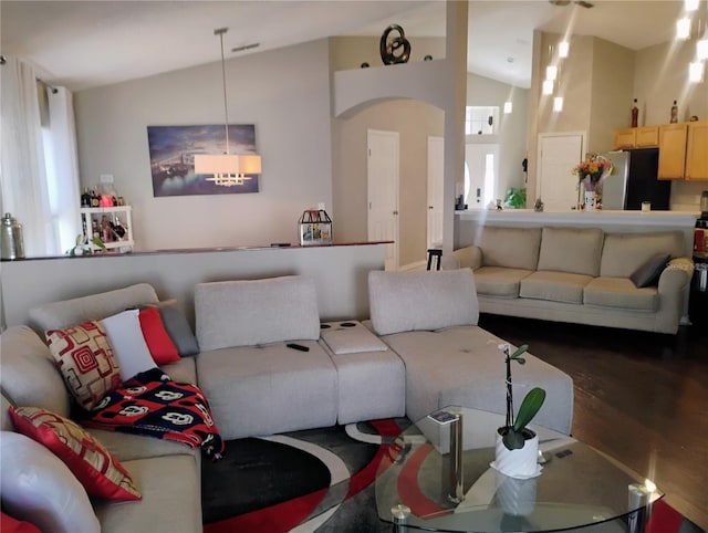 living room featuring lofted ceiling and wood finished floors