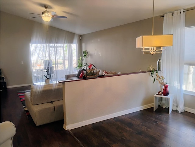 kitchen featuring dark wood-type flooring, a ceiling fan, and baseboards