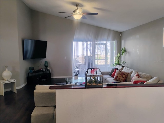 living area featuring dark wood-style floors, baseboards, and ceiling fan