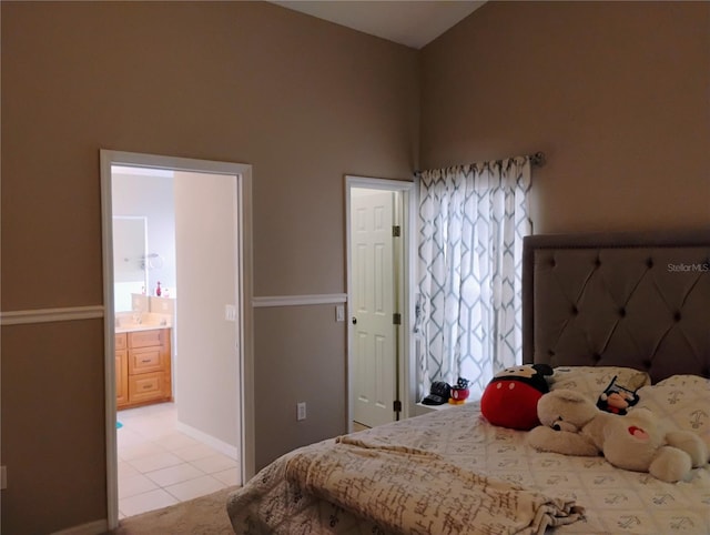 bedroom with baseboards and lofted ceiling