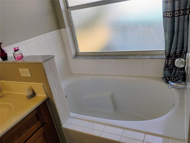 full bathroom with a bath and vanity