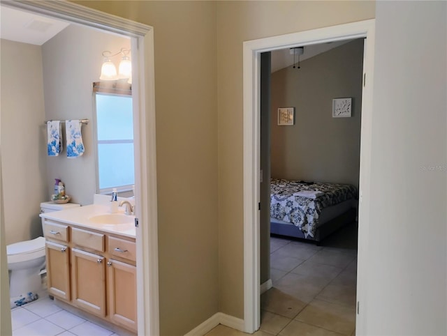 bathroom featuring vanity, toilet, and tile patterned flooring