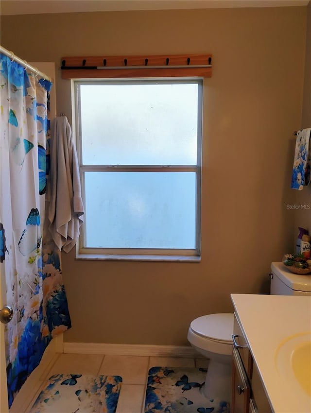 full bathroom with baseboards, toilet, vanity, and tile patterned flooring