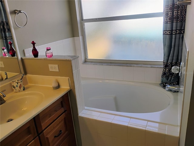 bathroom with vanity and a garden tub